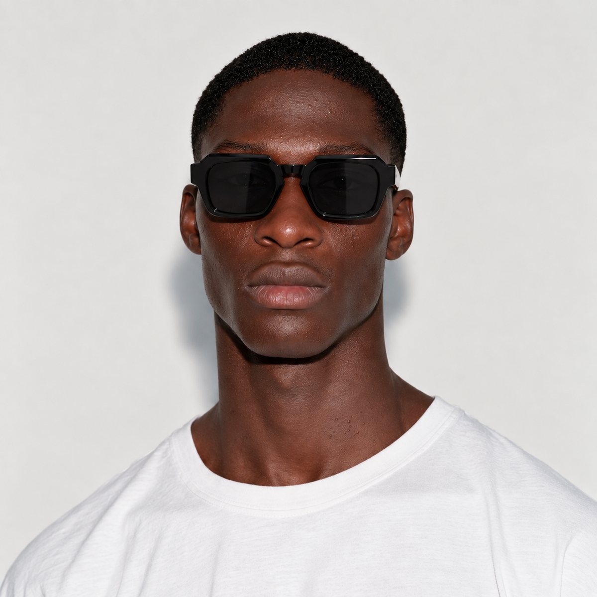 SET 01 — Checkout sunglasses in Black with grey lenses, worn by a model, front