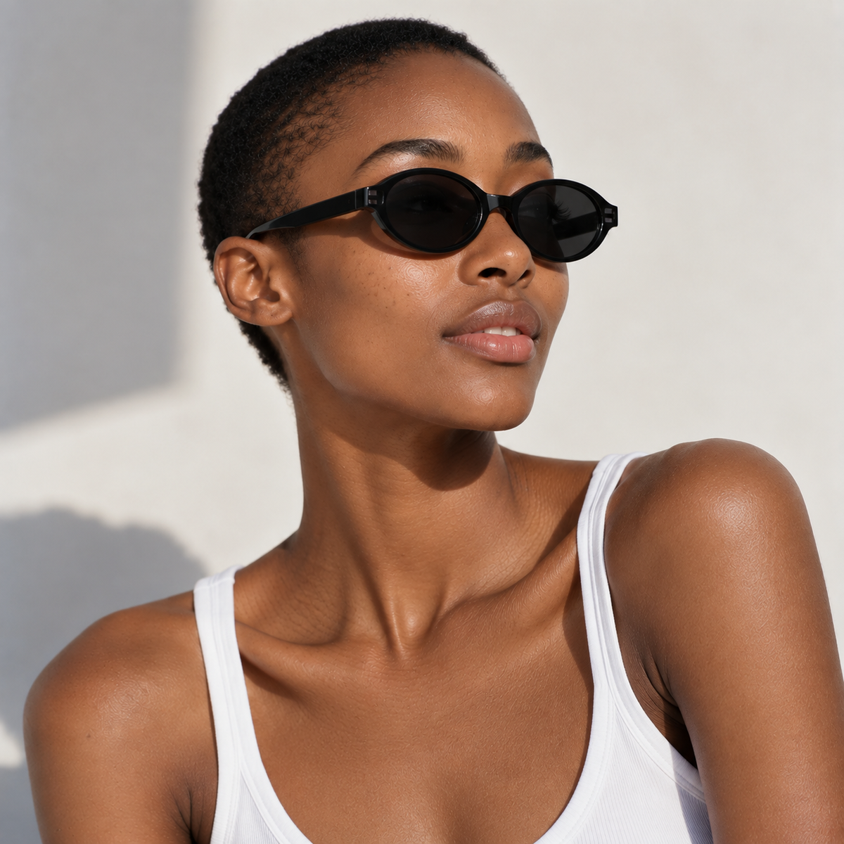 SET 05 — Plus One sunglasses in Black with grey lenses, worn by a model, side profile