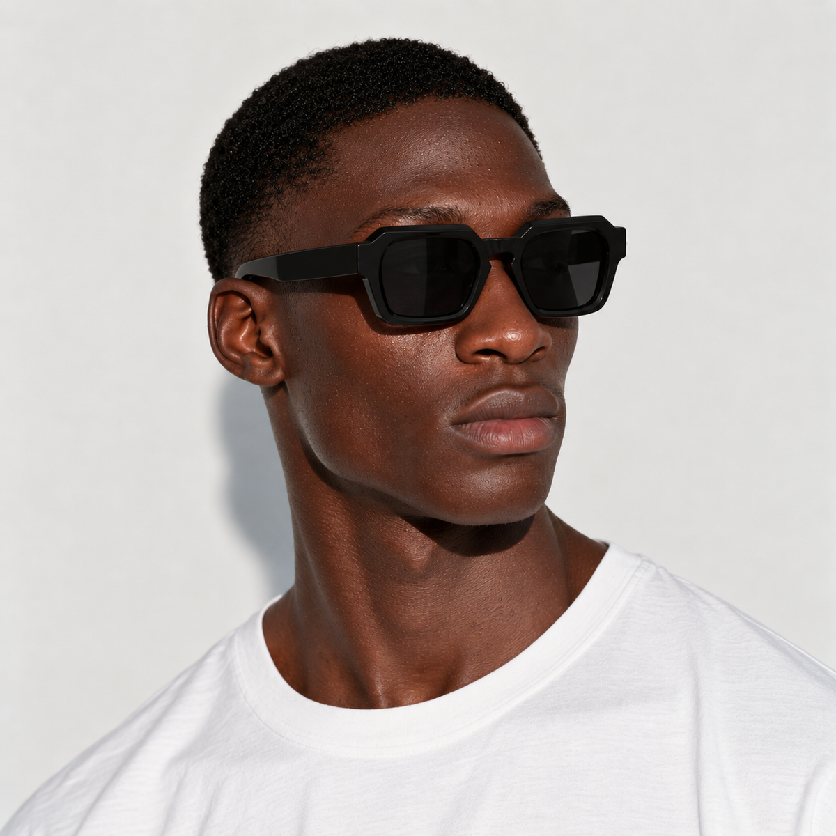SET 01 — Checkout sunglasses in Black with grey lenses, worn by a model, front